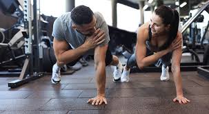 Image of man and woman doing Cardio Brentwood to tone their arms. 